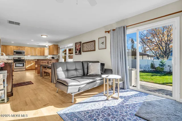 a living room with furniture and a floor to ceiling window