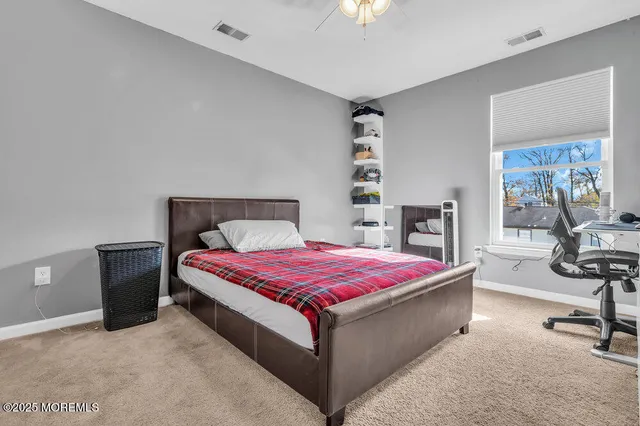 a bed room with a bed and a chair