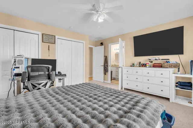 a bedroom with a bed and a flat screen tv in it