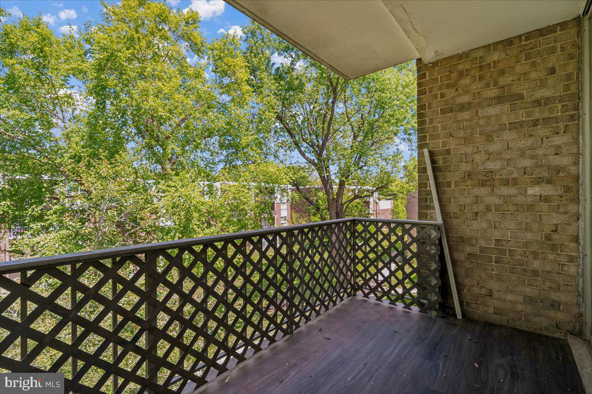 3940 Bel Pre Road, Unit 6 Silver Spring, MD 20906 - Photo 26 of 29 Serene balcony with lush greenery views.