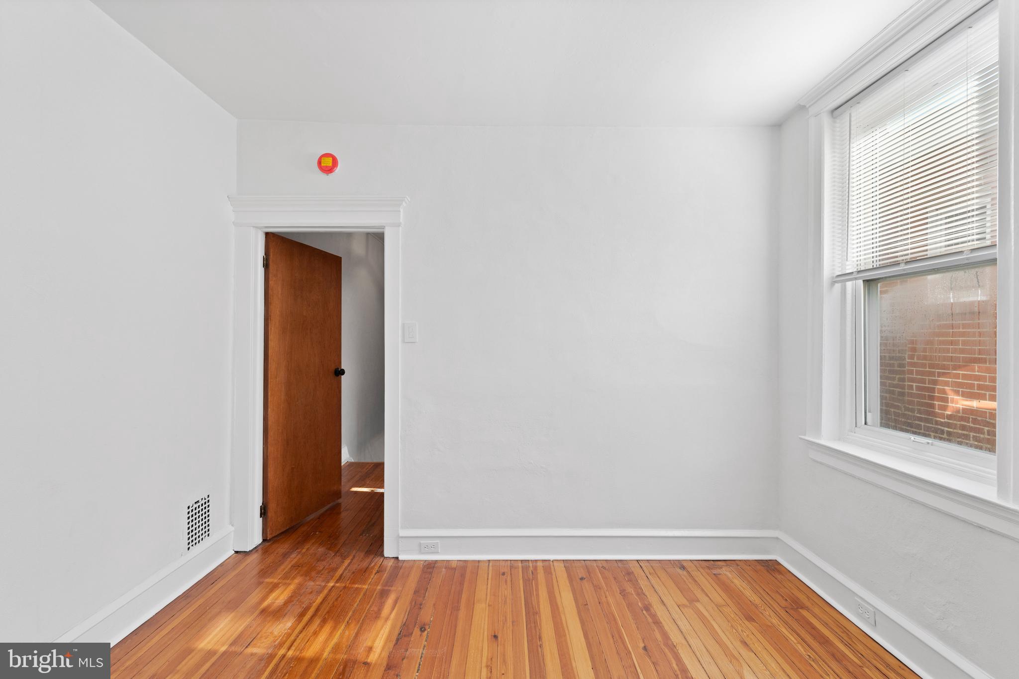 244 Mifflin Street Philadelphia, PA 19148 - Photo 14 of 21 a view of an empty room with wooden floor and a window