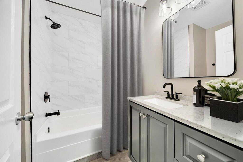 3936 Ross Road Gary, IN 46408 - Photo 11 of 18 a bathroom with a granite countertop sink a mirror and a bathtub