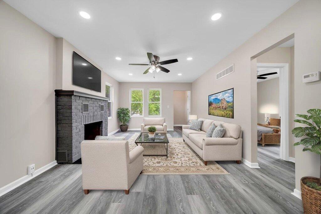 3936 Ross Road Gary, IN 46408 - Photo 3 of 18 a living room with furniture a fireplace and a flat screen tv