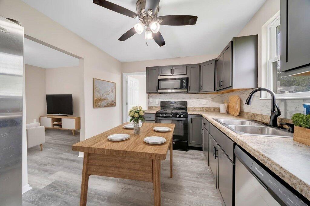 3936 Ross Road Gary, IN 46408 - Photo 7 of 18 a kitchen with sink a stove and cabinets