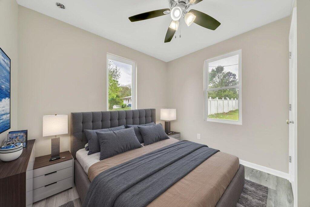 3936 Ross Road Gary, IN 46408 - Photo 9 of 18 a bedroom with a bed and a chandelier