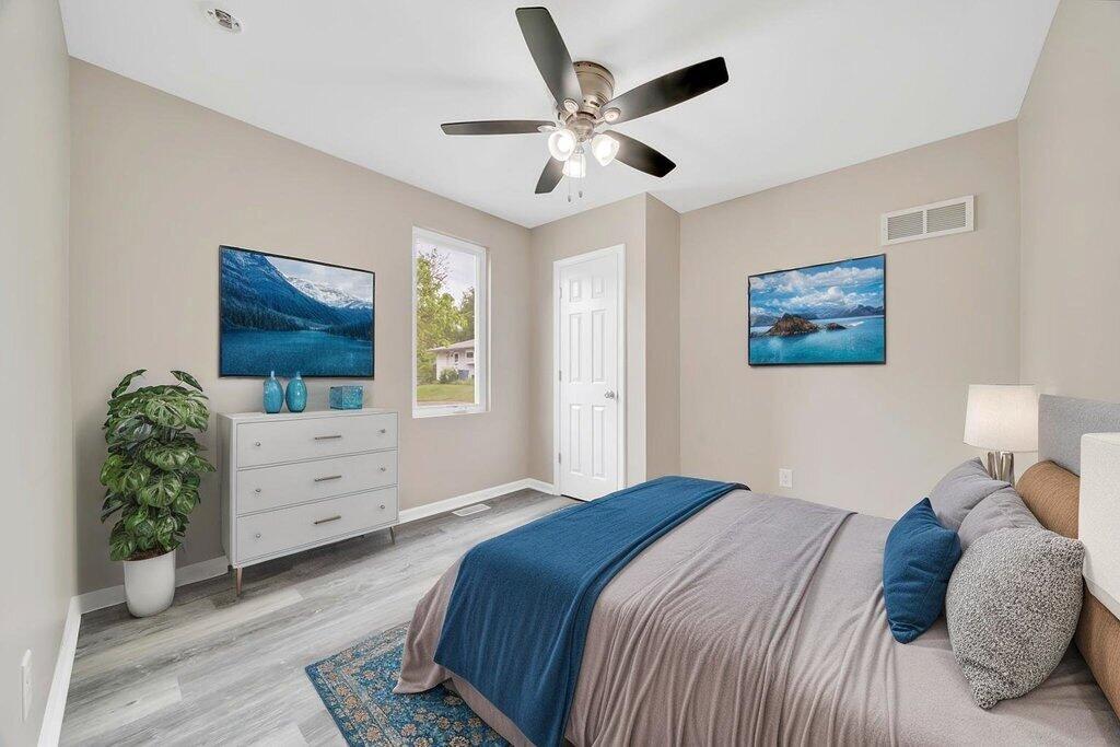 3936 Ross Road Gary, IN 46408 - Photo 10 of 18 a bedroom with a large bed and a chandelier