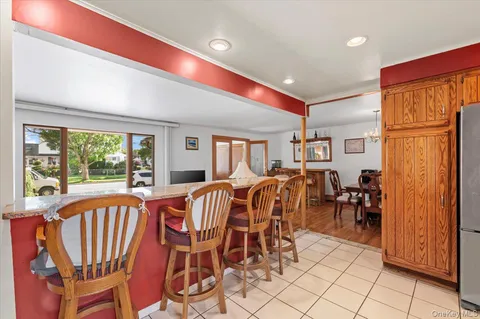 a bathroom with a granite countertop toilet sink and mirror