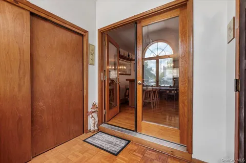 a living room with furniture a wooden floor and next to a window