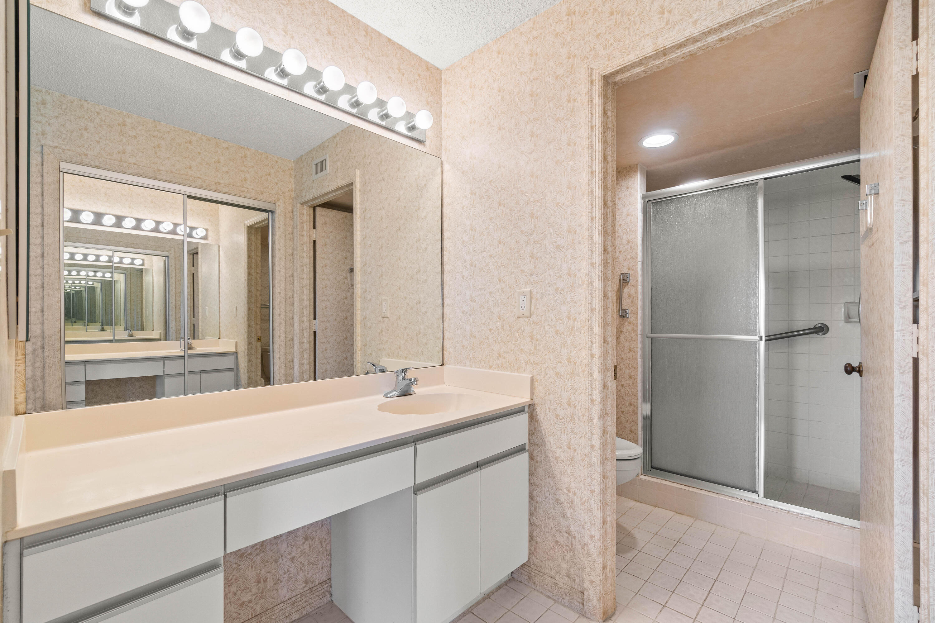 10920 Lakemore Lane, Unit 101 Boca Raton, FL 33498 - Photo 28 of 41 a bathroom with a sink and a mirror