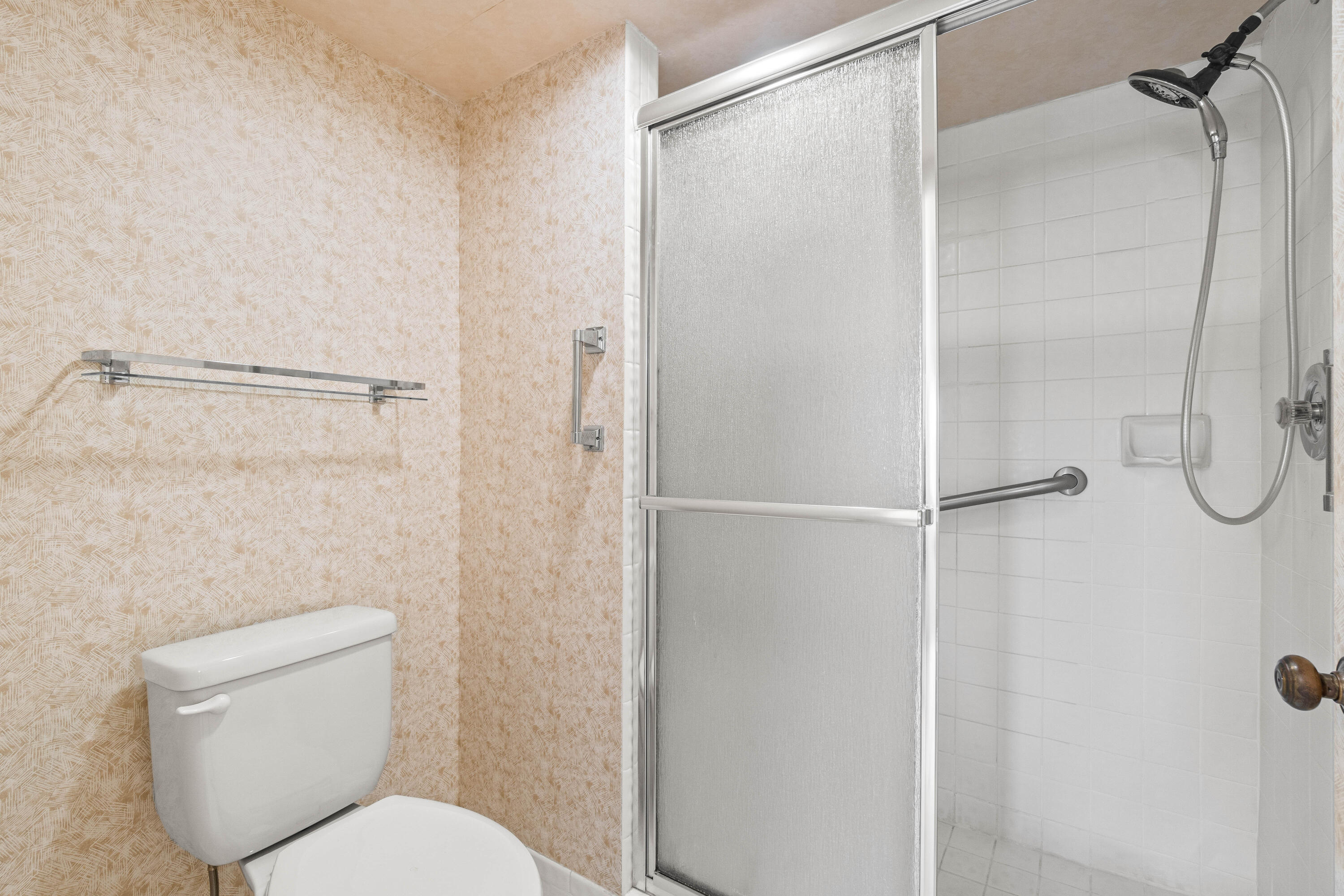 10920 Lakemore Lane, Unit 101 Boca Raton, FL 33498 - Photo 29 of 41 a white toilet sitting next to a shower