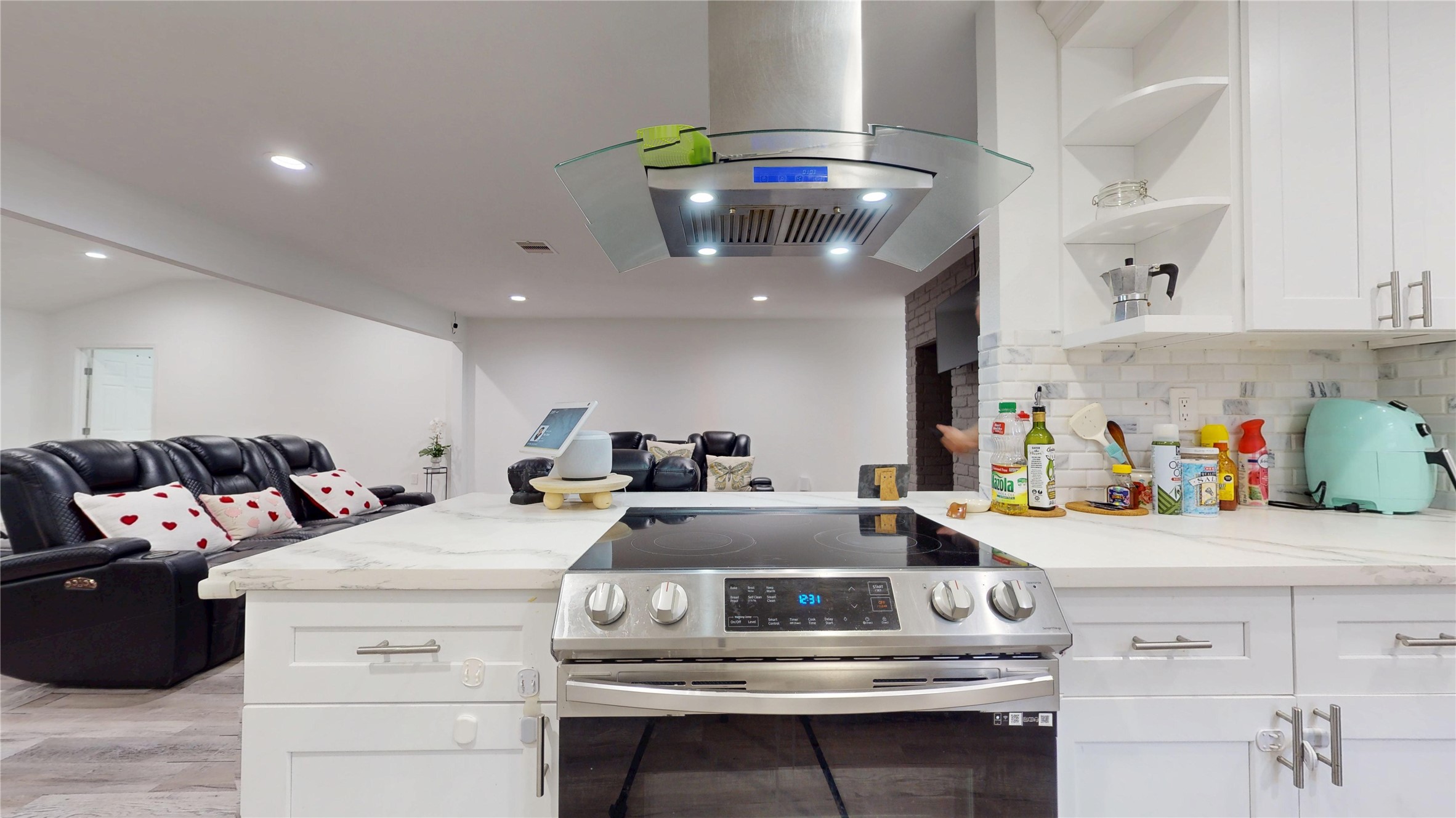 827 Dondell Street Channelview, TX 77530 - Photo 11 of 49 827 Dondell St, Kitchen stove with stainless steal vent above it, white cabinetry.