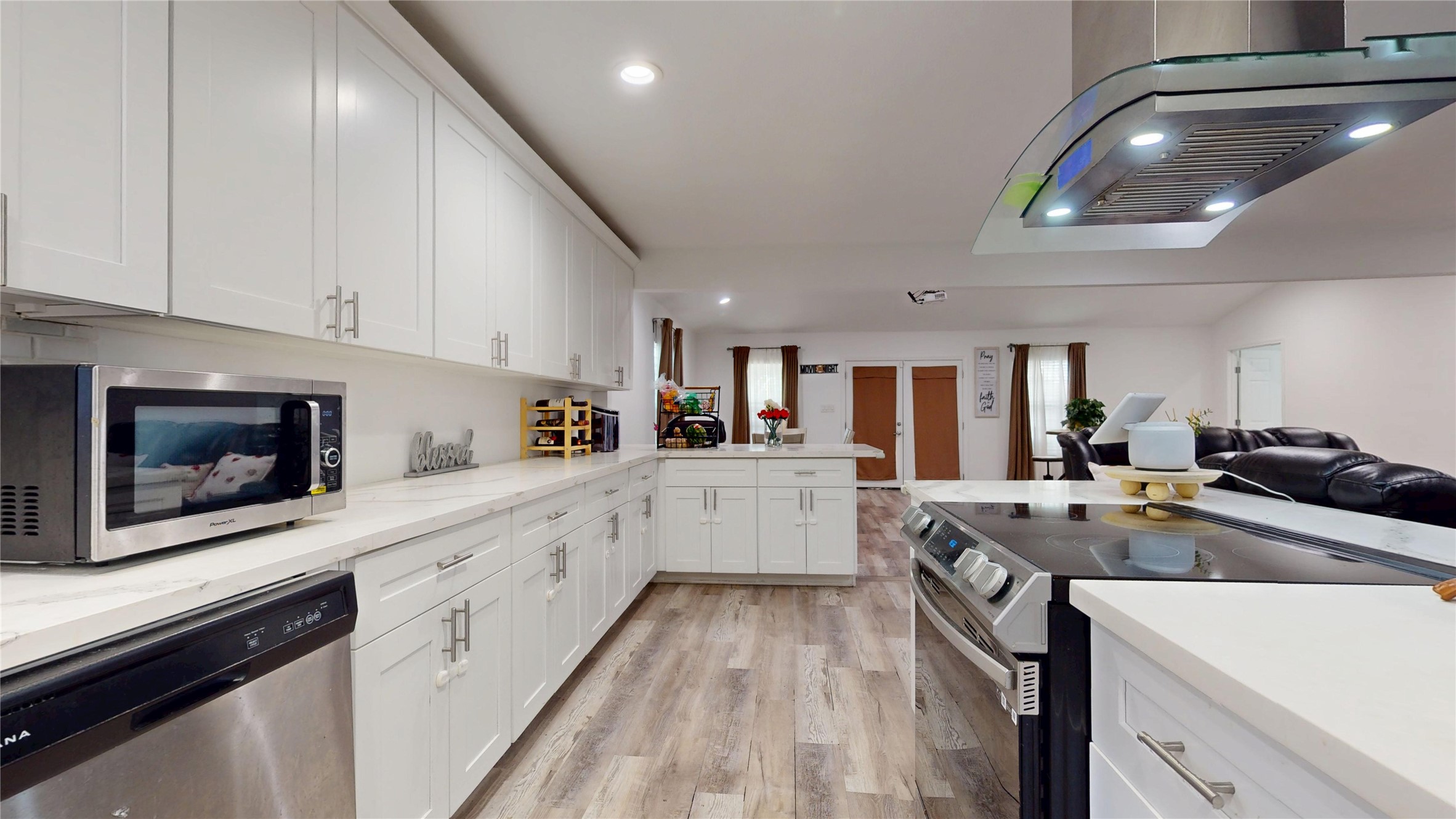 827 Dondell Street Channelview, TX 77530 - Photo 12 of 49 827 Dondell St, Kitchen with white cabiets and open dining and living area.