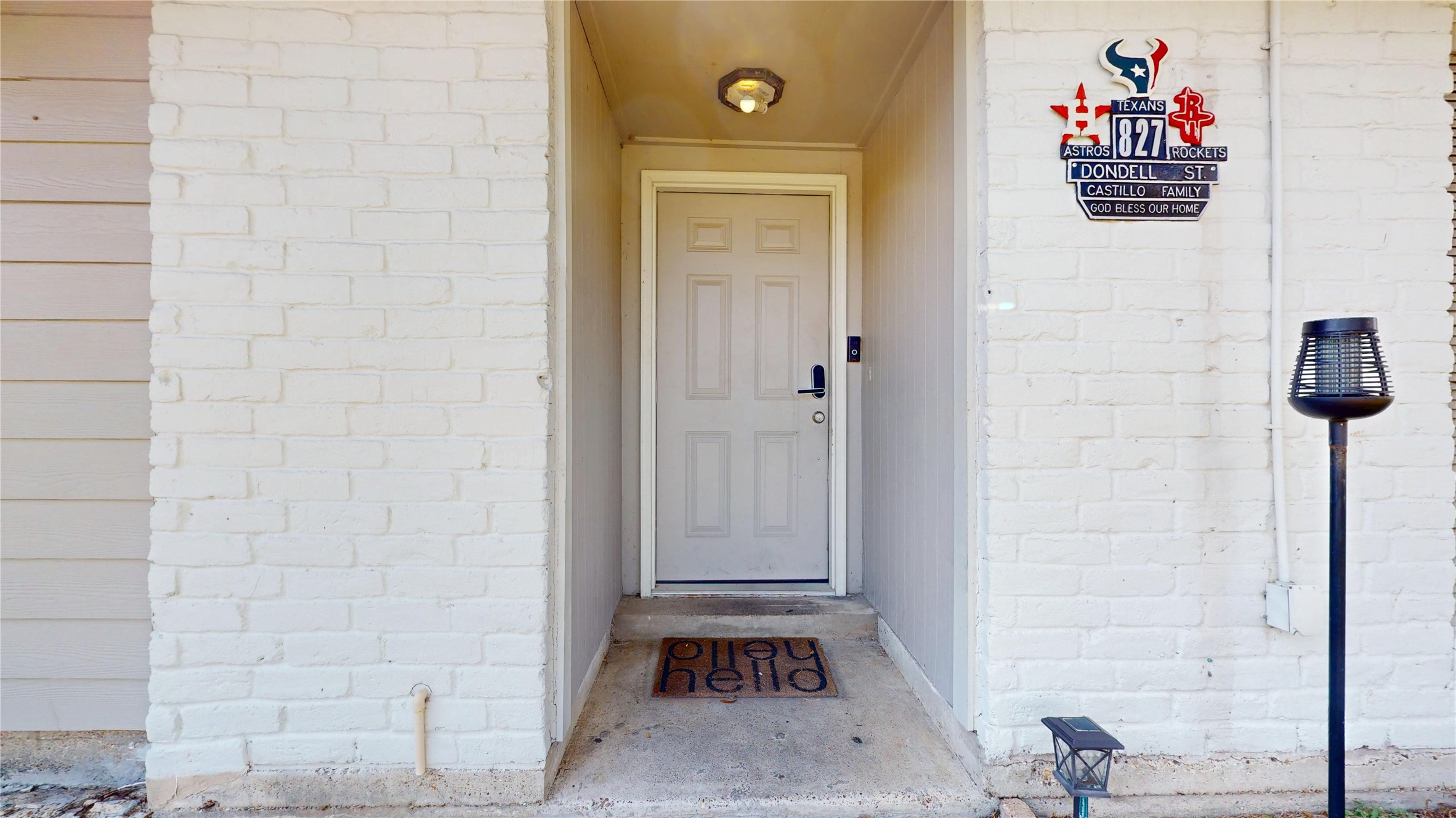 827 Dondell Street Channelview, TX 77530 - Photo 2 of 49 827 Dondell St, Soft gray wooden entrance door, white brick home.