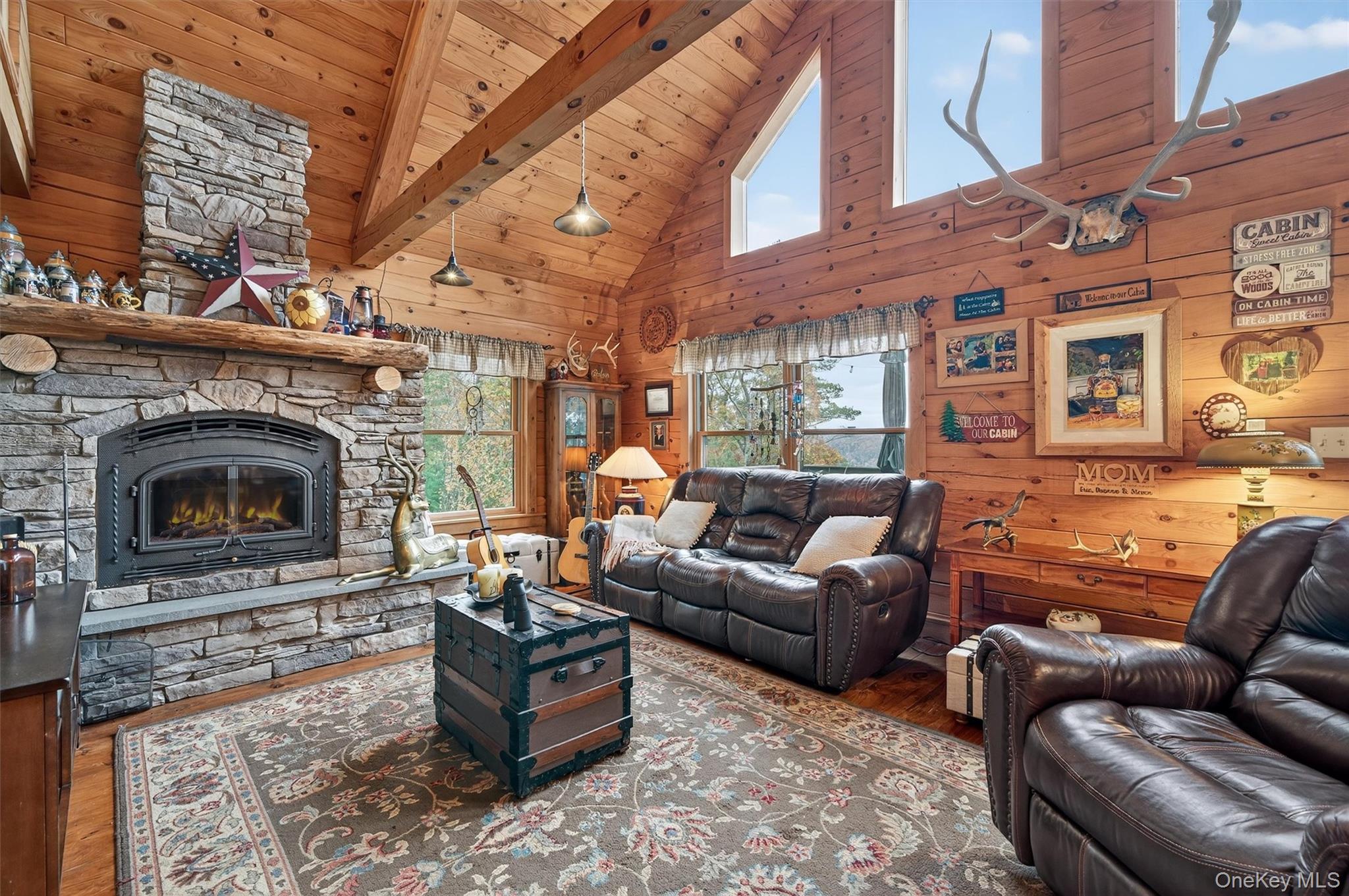 129 Hallock Road Barryville, NY 12719 - Photo 2 of 18 a living room with furniture a fireplace and a wall painting