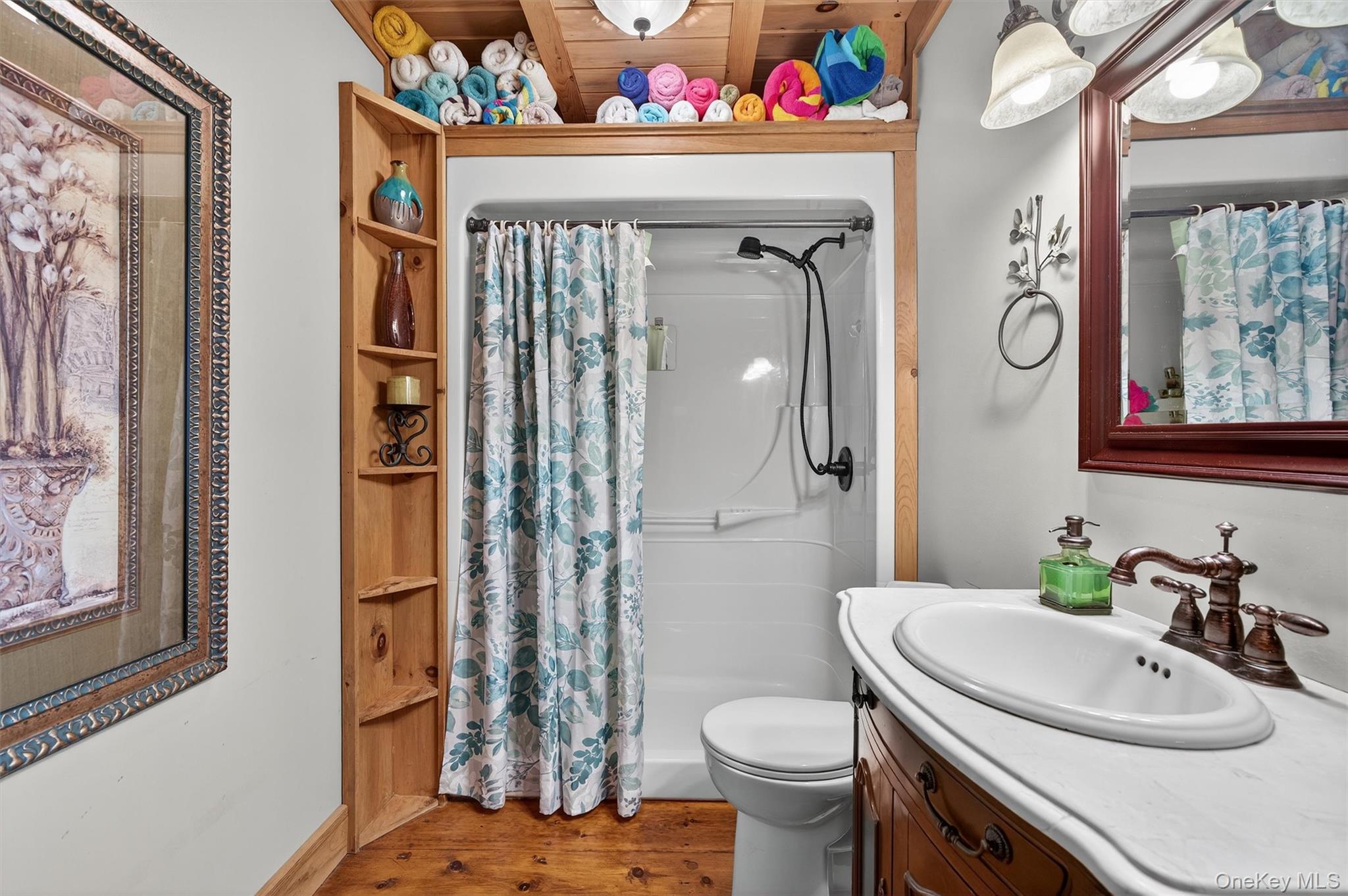 129 Hallock Road Barryville, NY 12719 - Photo 9 of 18 a bathroom with a sink a toilet and shower curtain