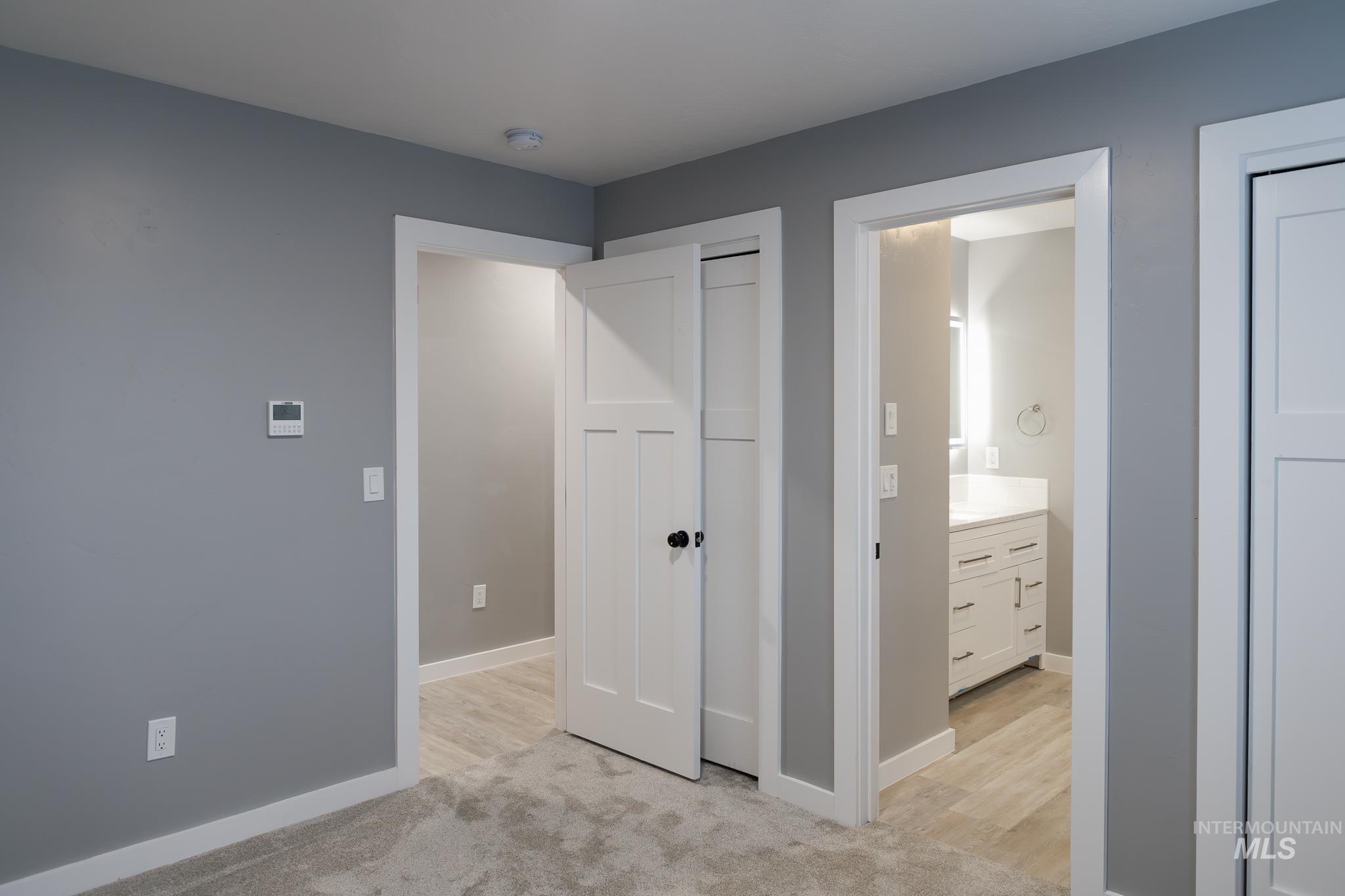 287 Southwest 6th Street, Unit 1 Ontario, OR 97914 - Photo 15 of 49 Unfurnished bedroom featuring light carpet and connected bathroom