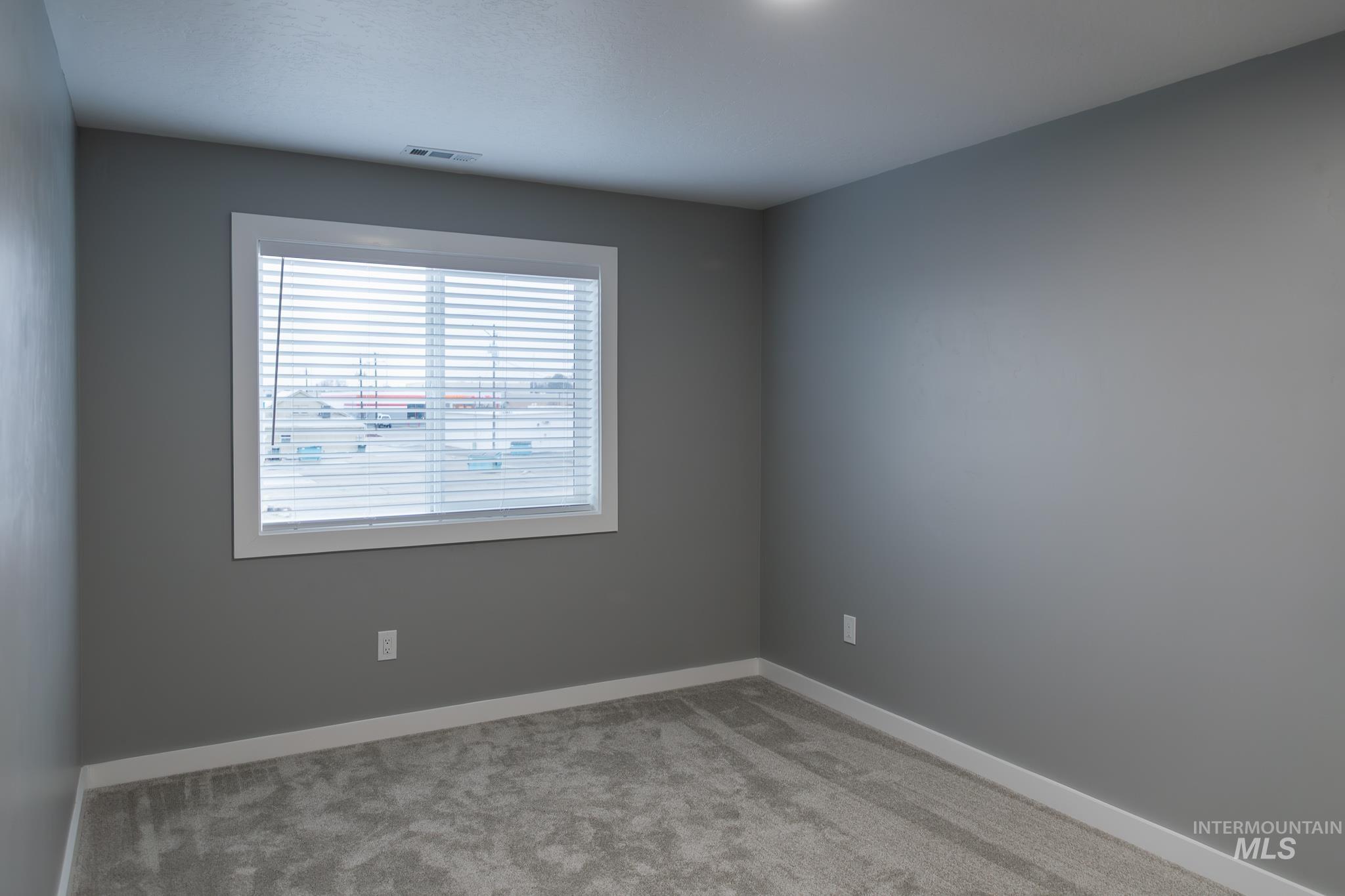 287 Southwest 6th Street, Unit 1 Ontario, OR 97914 - Photo 36 of 49 Carpeted spare room featuring baseboards