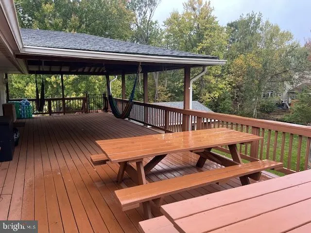 a view of balcony with wooden floor and outdoor seating