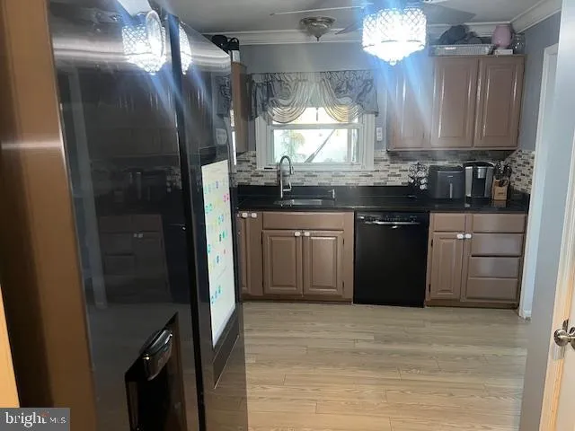 a kitchen with stainless steel appliances granite countertop a refrigerator a sink a stove and dishwasher