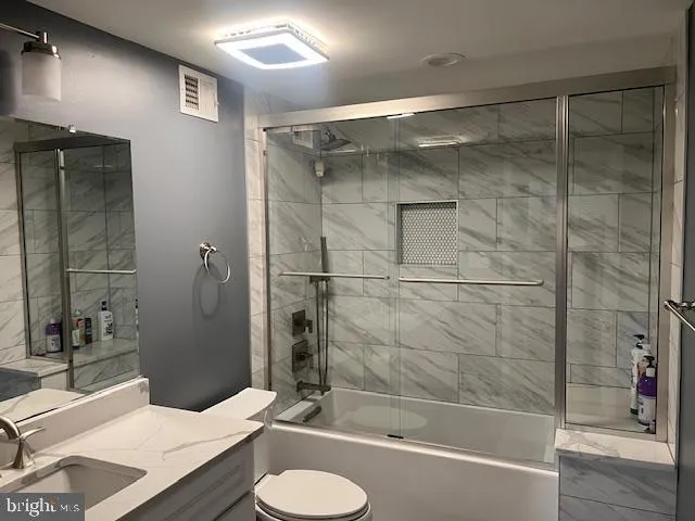 a bathroom with a sink and mirror with bathtub