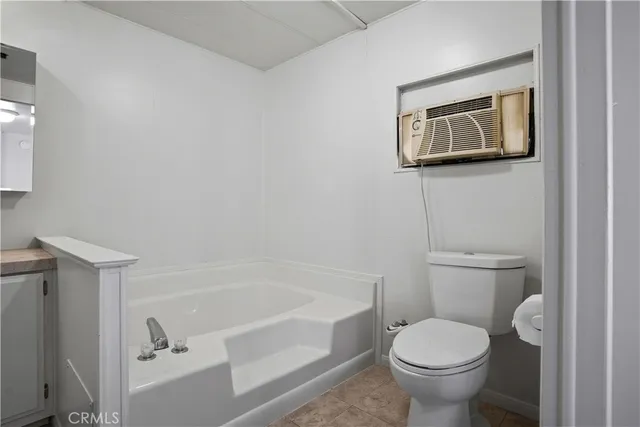 a bathroom with a toilet and a bathtub