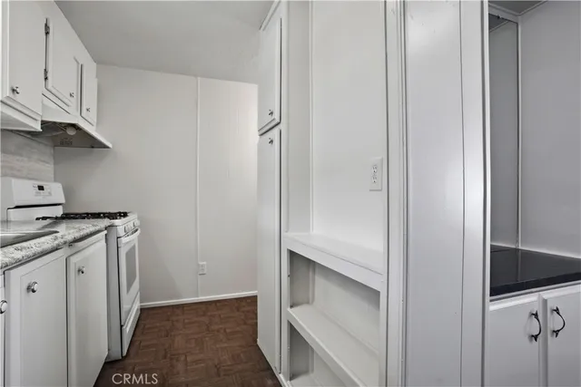a kitchen with cabinets and a stove top oven