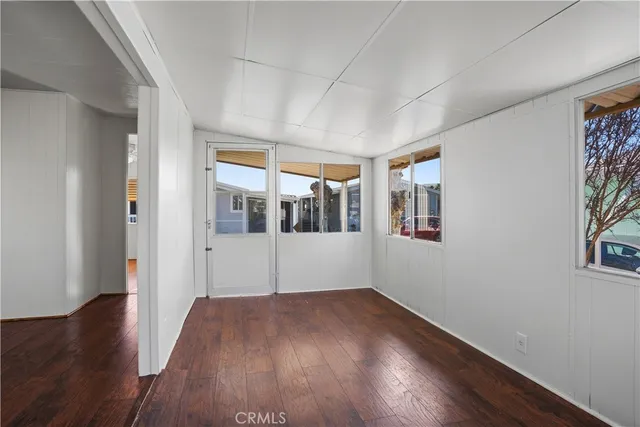 a big room with wooden floor and windows