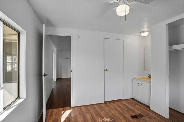 a view of a bedroom with wooden floor