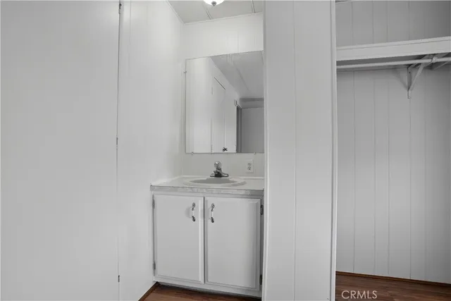 a bathroom with a granite countertop sink a toilet and a mirror
