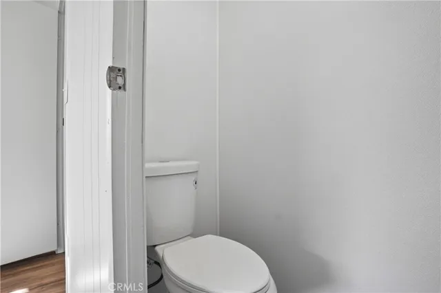a white toilet sitting next to a shower