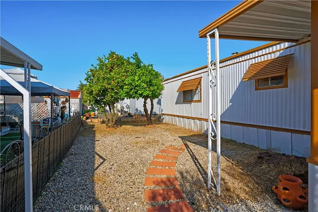 a view of a house with backyard and sitting area
