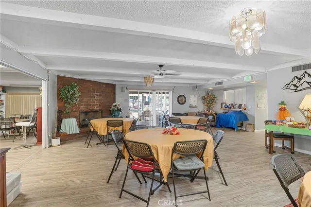 a dining room with furniture a chandelier and wooden floor