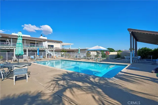 a swimming pool with outdoor seating and yard