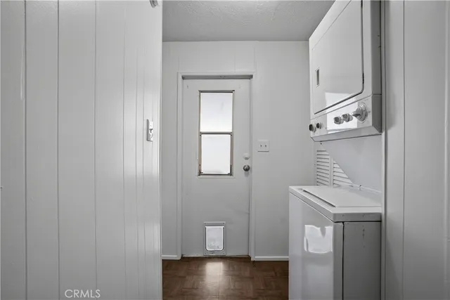 a hallway with front door wooden floor and stairs