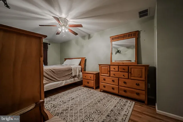 a bedroom with a bed and a dresser in it