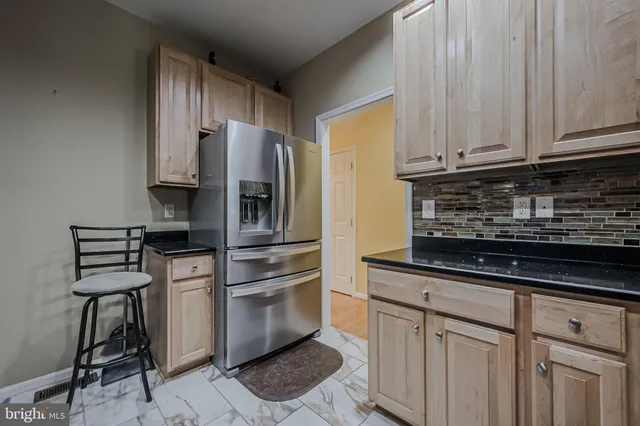 a kitchen with stainless steel appliances a sink cabinets and a refrigerator