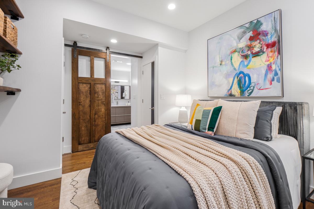 2107 S Street Northwest, Unit M Washington, DC 20008 - Photo 13 of 30 a bedroom with a bed and painting on the wall