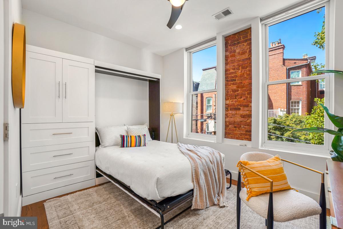 2107 S Street Northwest, Unit M Washington, DC 20008 - Photo 16 of 30 a bedroom with a bed and chair