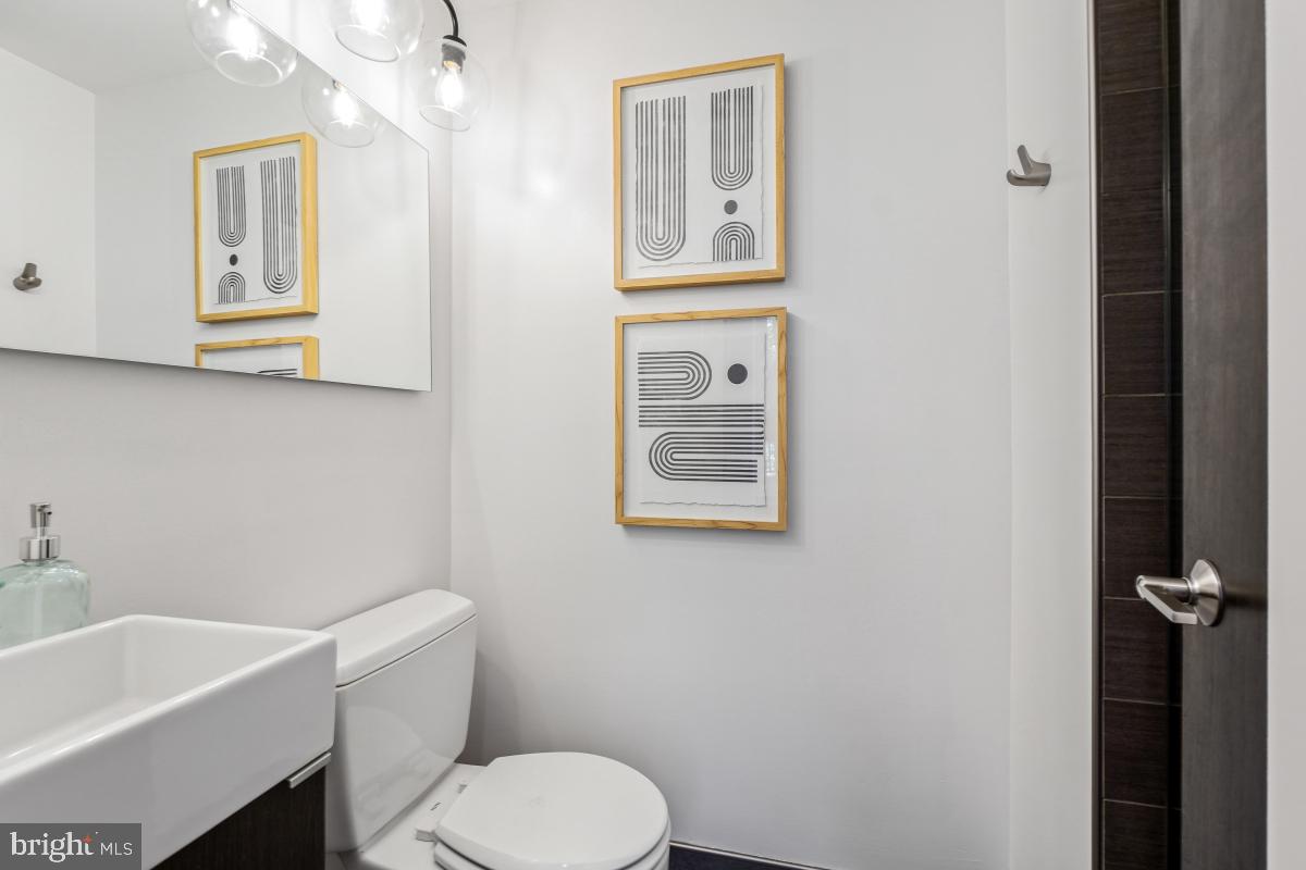 2107 S Street Northwest, Unit M Washington, DC 20008 - Photo 19 of 30 a white toilet sitting next to a bathroom sink