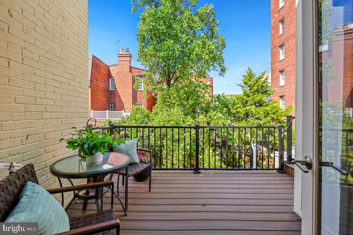 2107 S Street Northwest, Unit M Washington, DC 20008 - Photo 20 of 30 a view of a balcony with table and chairs and potted plants