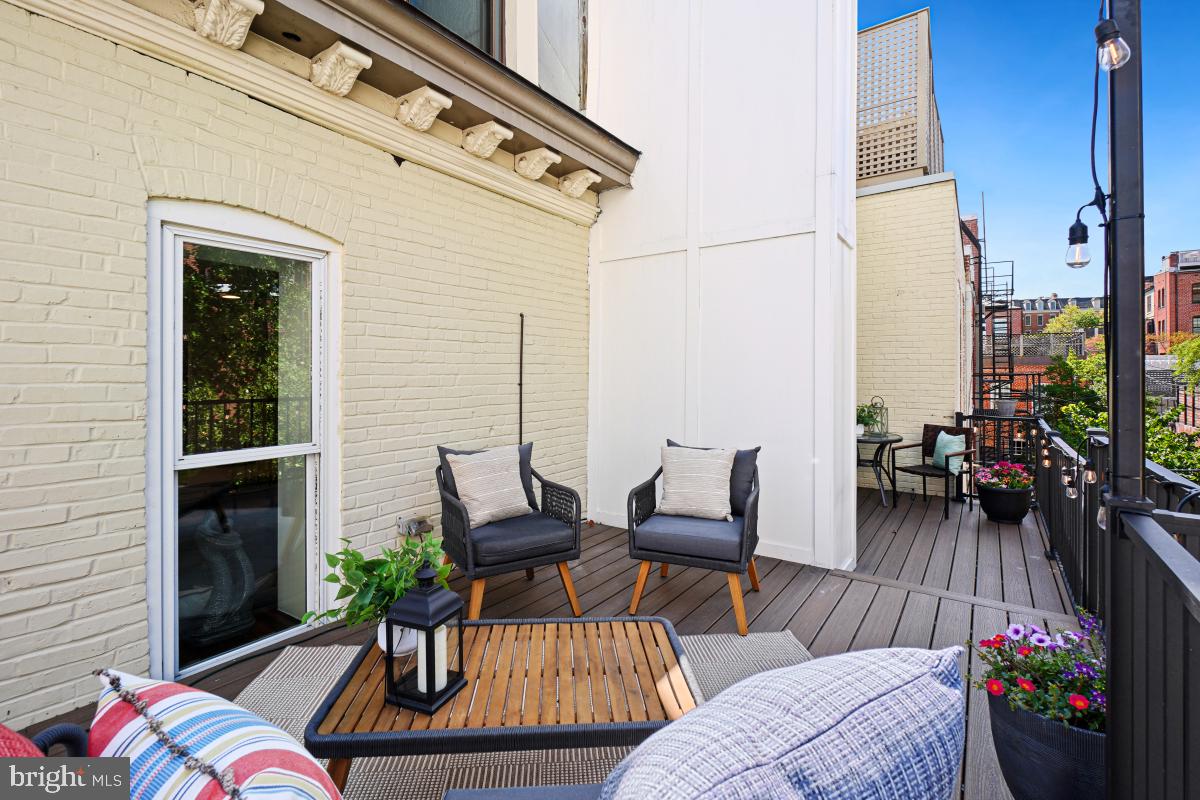 2107 S Street Northwest, Unit M Washington, DC 20008 - Photo 22 of 30 a view of a patio with couches table and chairs and potted plants