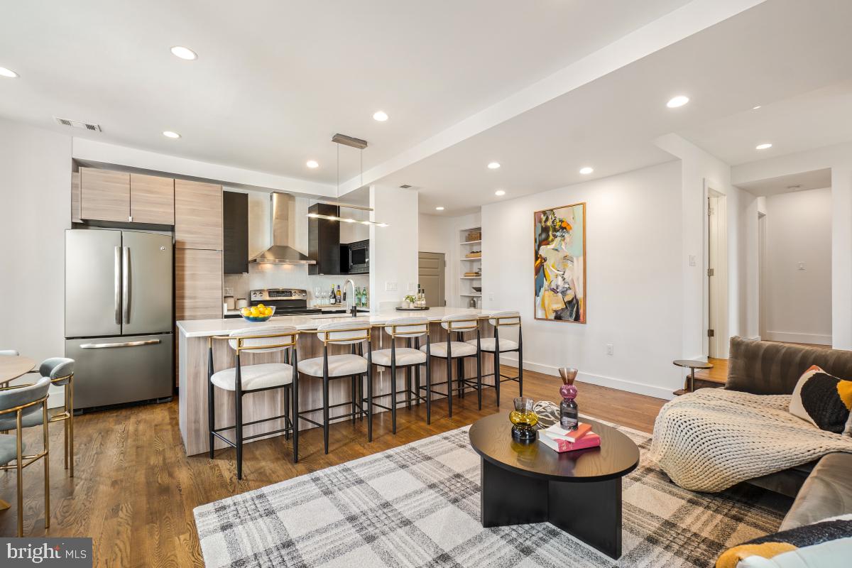 2107 S Street Northwest, Unit M Washington, DC 20008 - Photo 6 of 30 a kitchen with a dining table and chairs