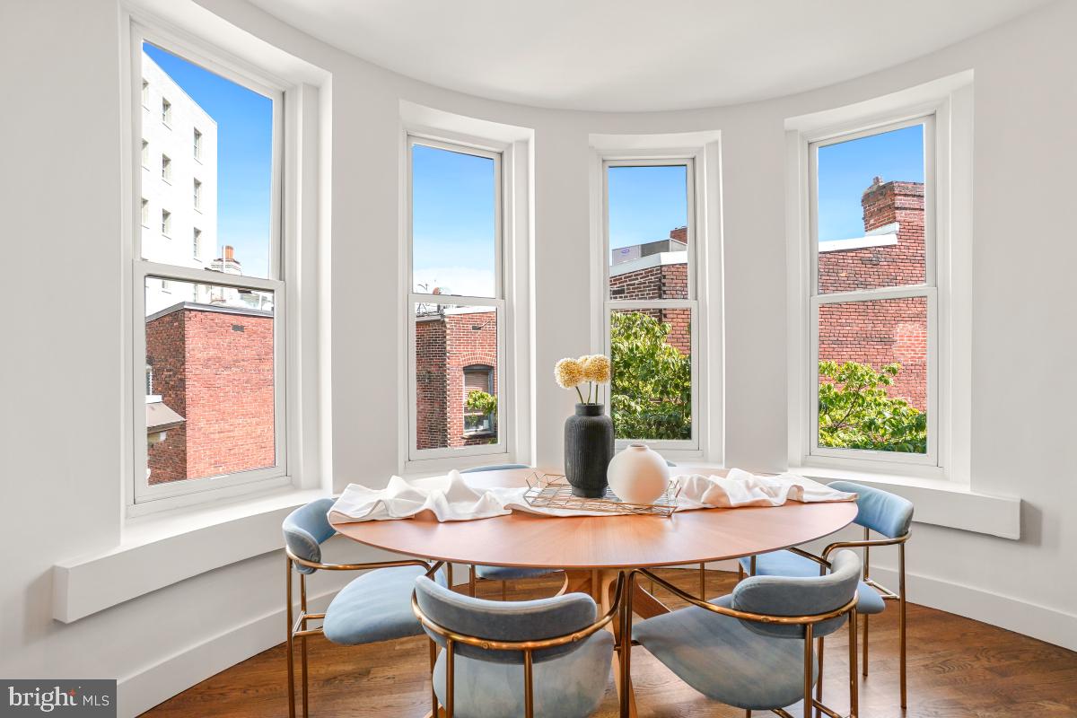 2107 S Street Northwest, Unit M Washington, DC 20008 - Photo 7 of 30 a view of a dining room with furniture and wooden floor