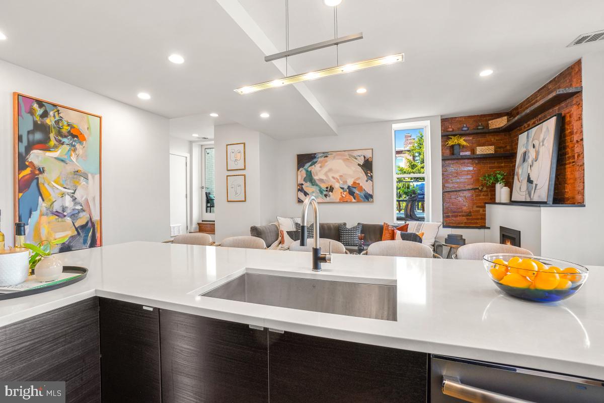 2107 S Street Northwest, Unit M Washington, DC 20008 - Photo 9 of 30 a kitchen with stainless steel appliances a sink dishwasher and cabinets with wooden floor