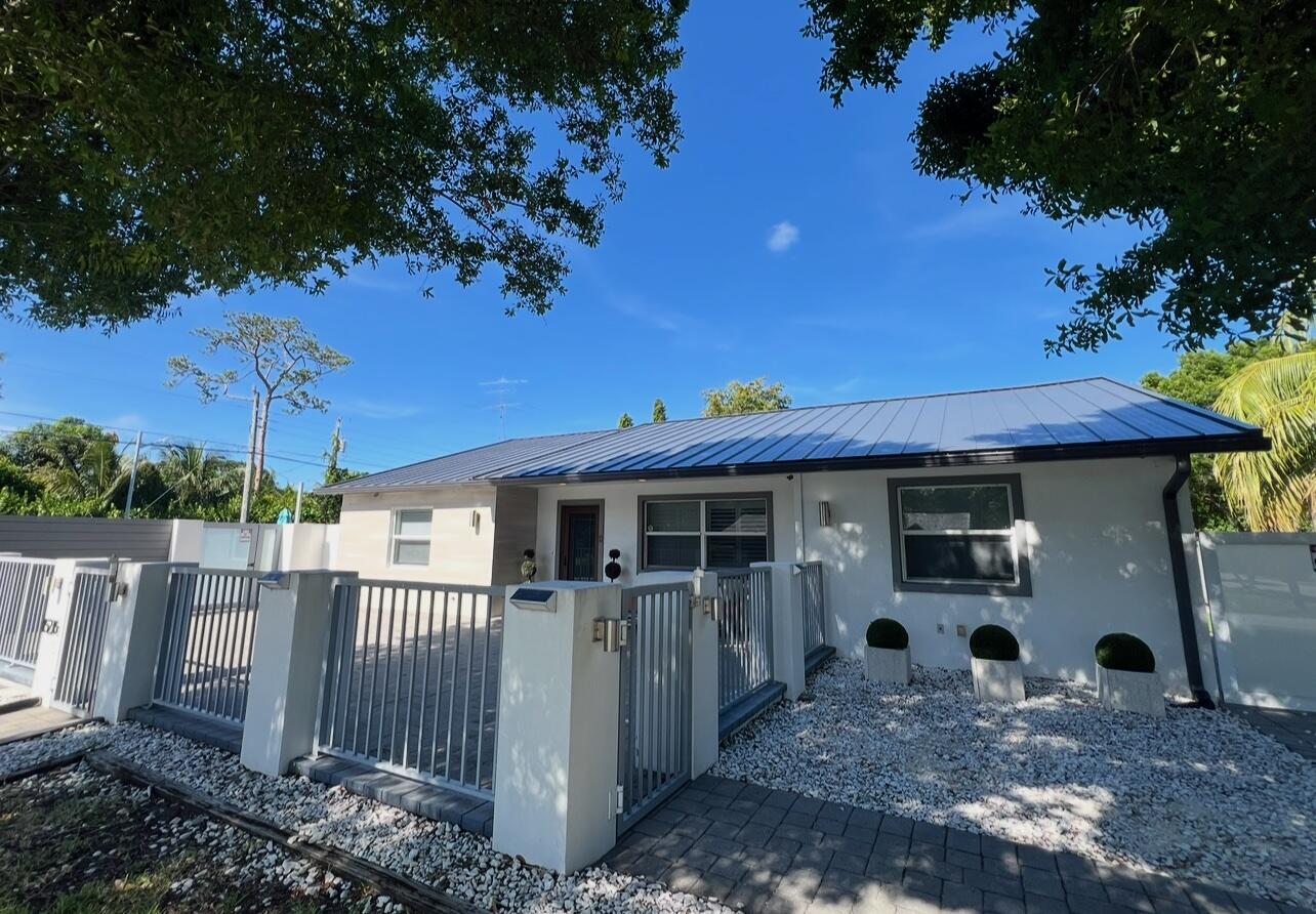 15276 Harrison Road Delray Beach, FL 33484 - Photo 73 of 75 a view of a house with backyard and a tree