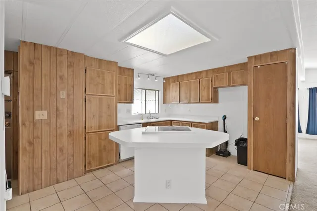 a kitchen with kitchen island a sink table and chairs