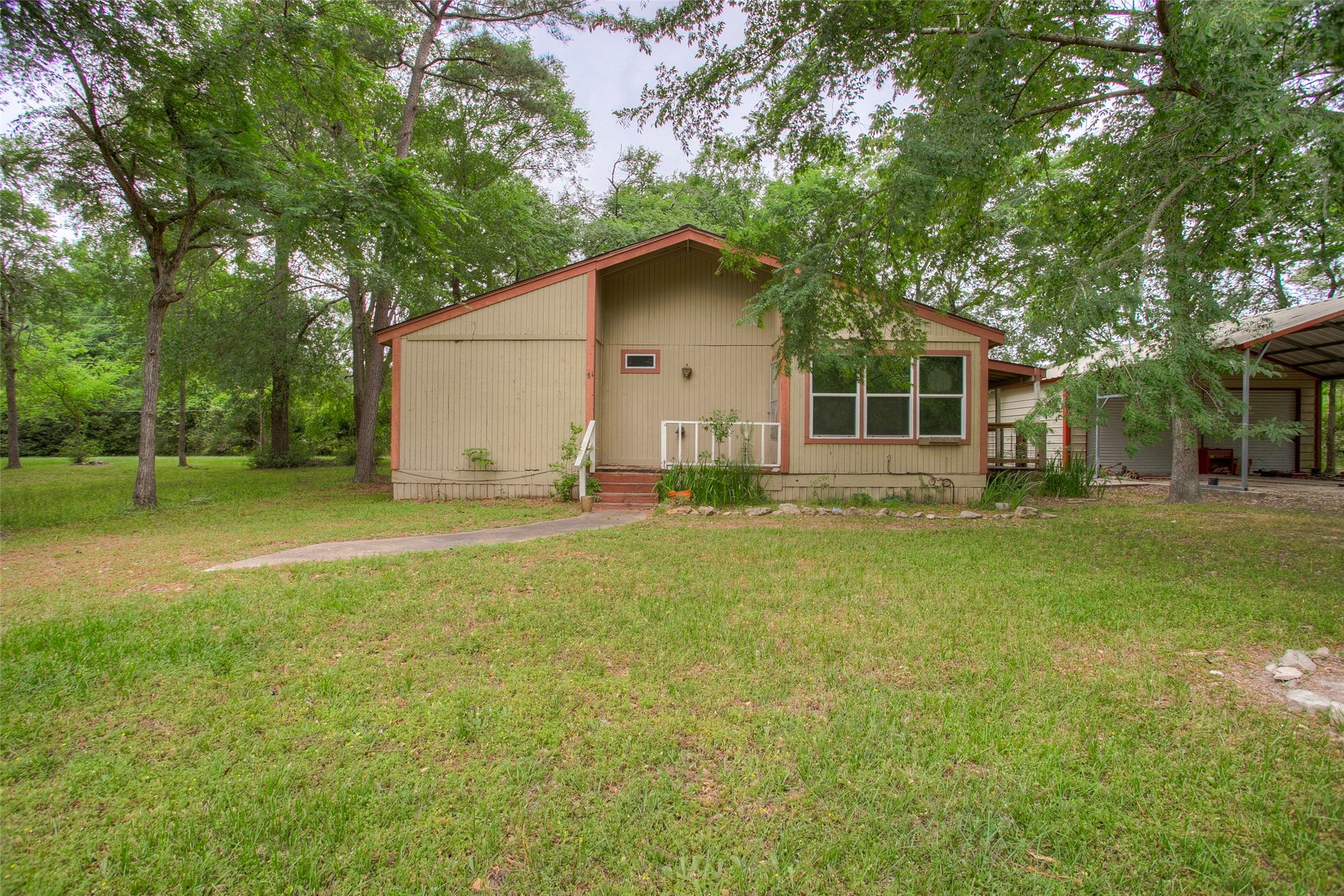81 Westlake Road Trinity, TX 75862 - Photo 2 of 23 a house view with a garden space