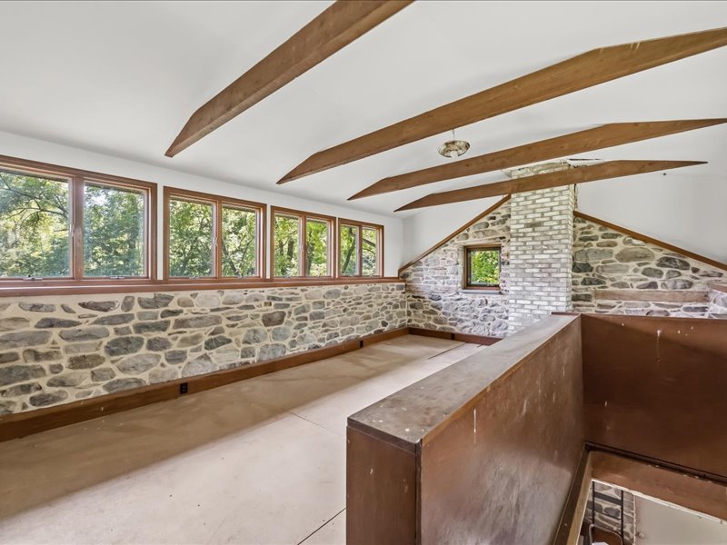 1168 Mt Pleasant Road Bangor, PA 18013 - Photo 97 of 100 Exposed collar ties and rustic stone walls define this character-filled upper-level loft space.