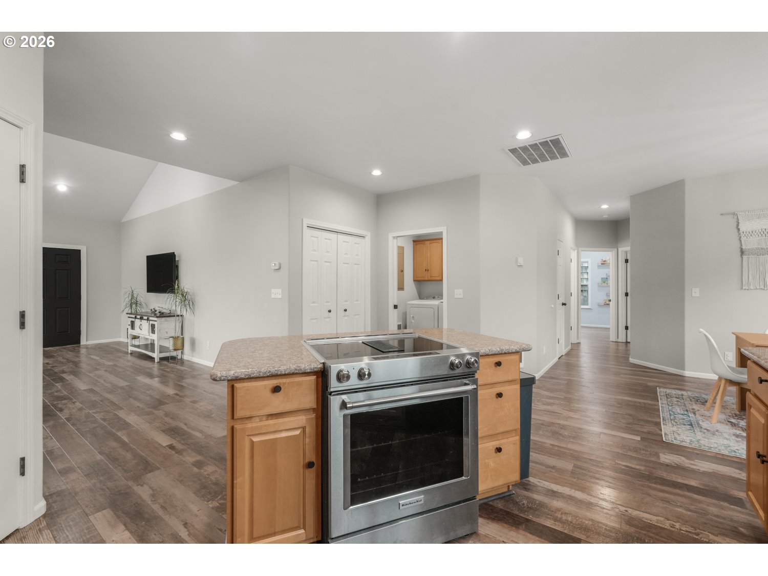 2927 Ruby Court Bandon, OR 97411 - Photo 11 of 38 a kitchen with stainless steel appliances granite countertop a stove top oven a sink dishwasher and a refrigerator with wooden floor