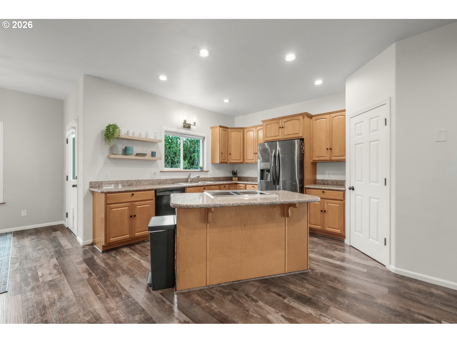 2927 Ruby Court Bandon, OR 97411 - Photo 12 of 38 a kitchen with stainless steel appliances granite countertop a sink a stove a refrigerator and a microwave